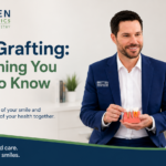 Periodontist explaining gum grafting treatment to a patient using a gum model